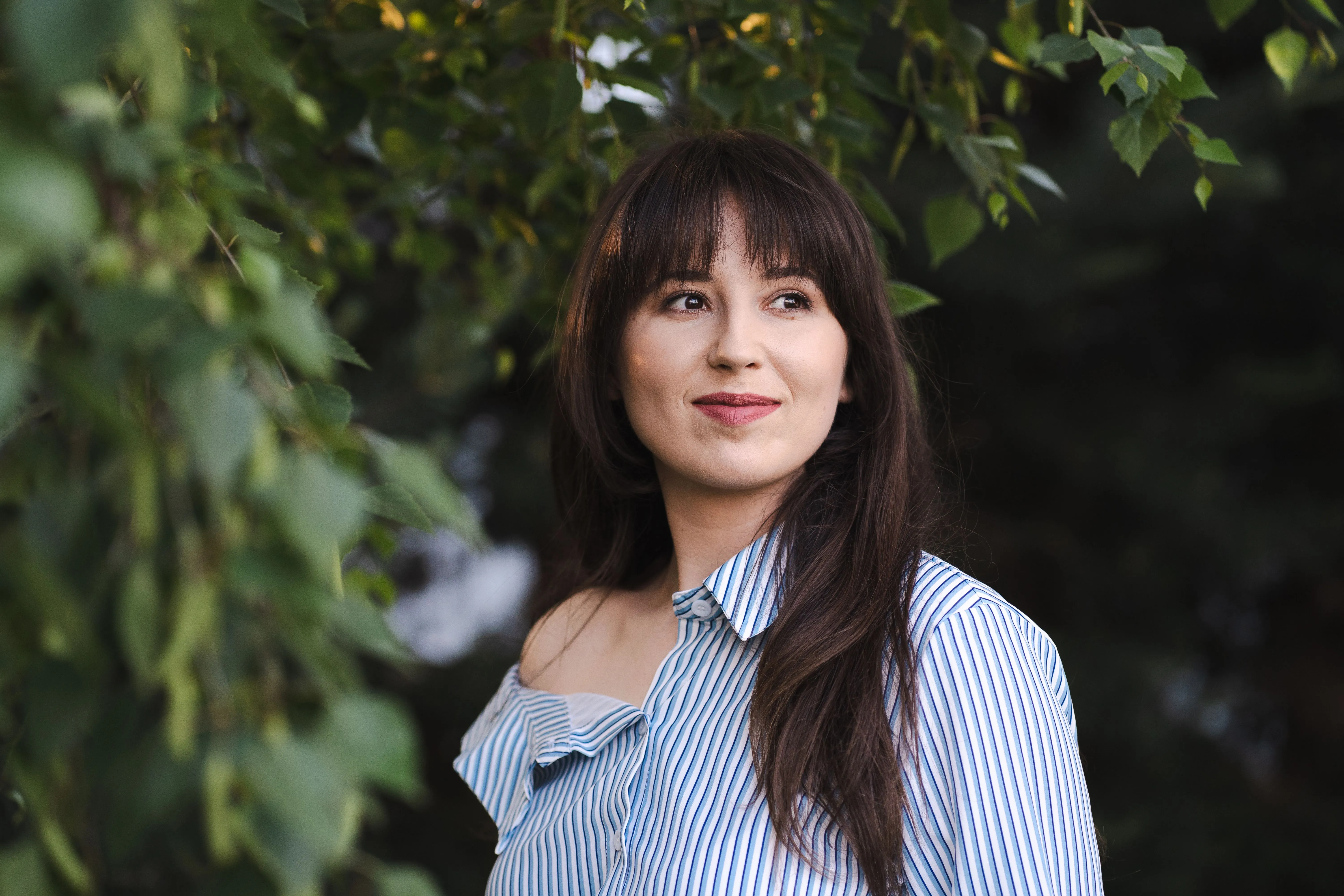Žena s curtain bangs a dlouhými vrstvami
